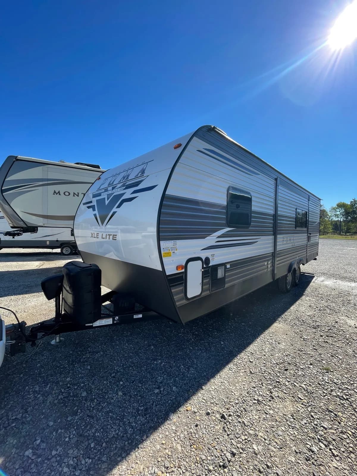 Travel trailer under a clear blue sky